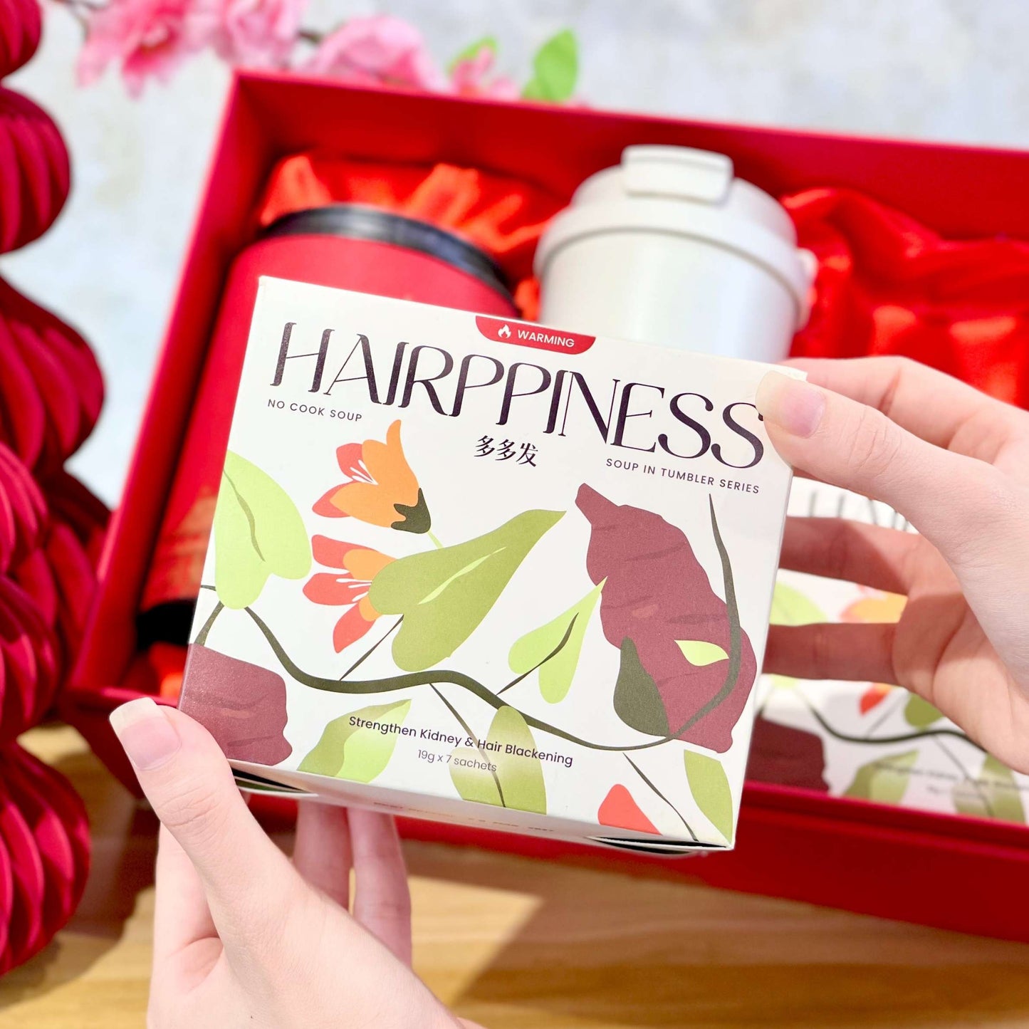 Hand holding benafit no cook soup 2026 chinese new year bundles  'Hairppiness' no cook soup box package malaysia